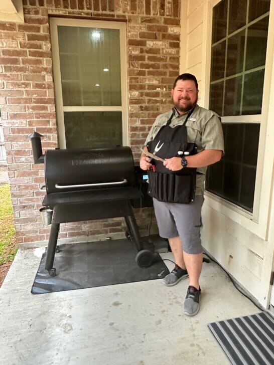 man in front of smoker/grill