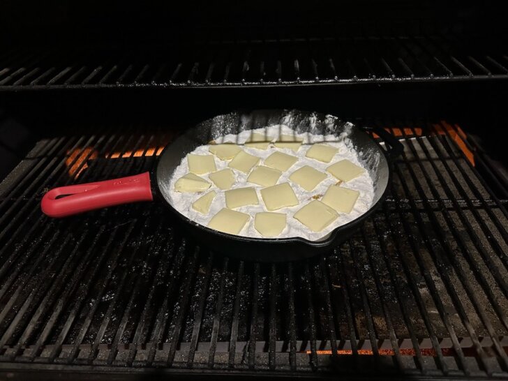 Peaches, cake mix and butter in cast-iron skillet