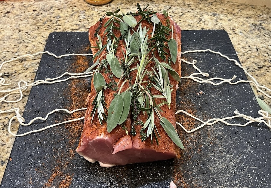 Pork tenderloin with herbs and twine