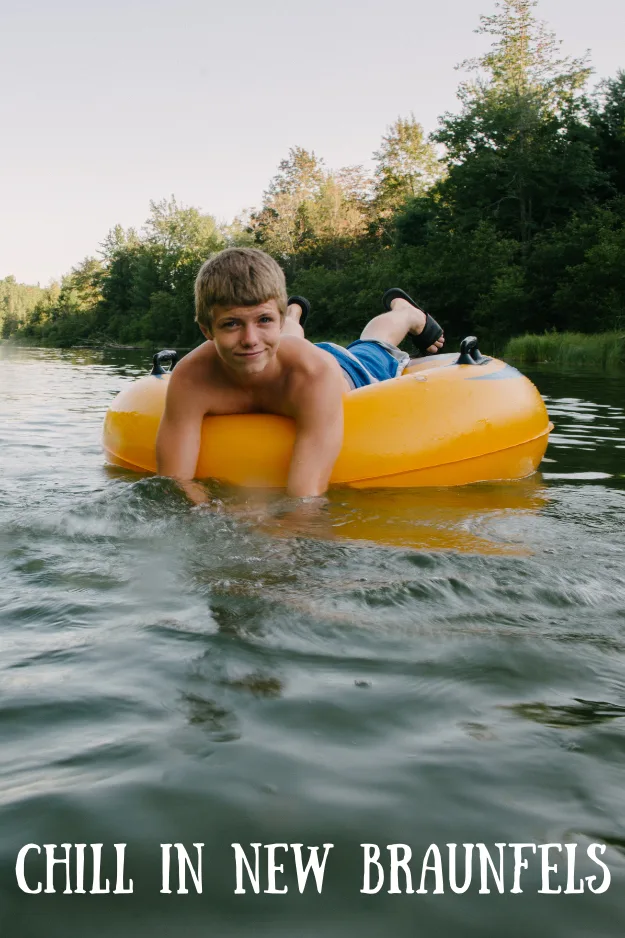 boy floating on innertube down a peaceful river and text reading Chill in New Braunfels
