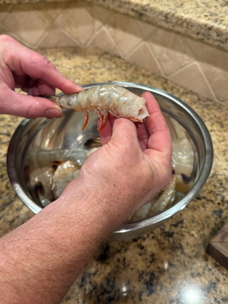 raw shrimp being cleaned