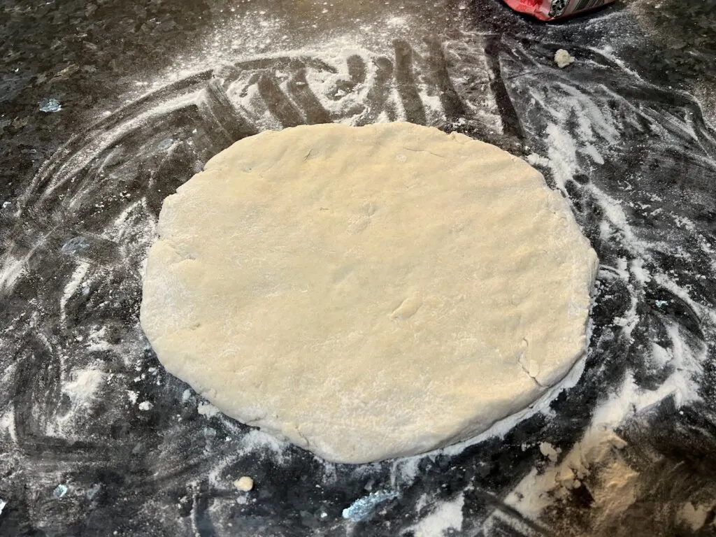 biscuit dough on floured surface patted down