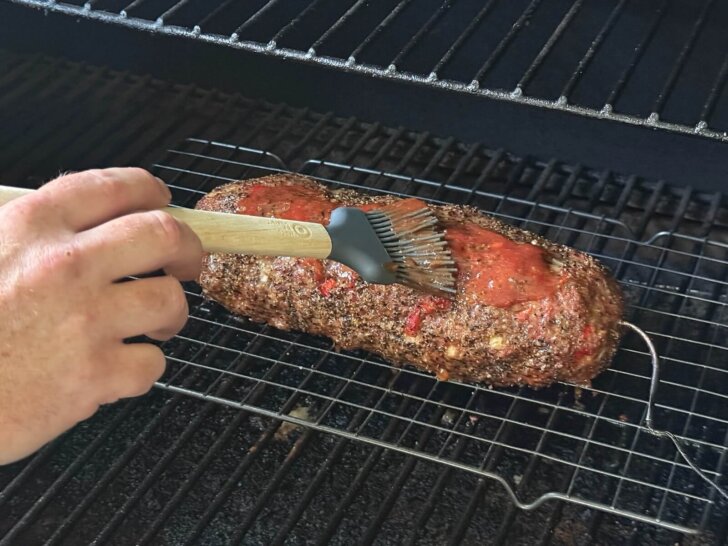 adding glaze to meatloaf on grill