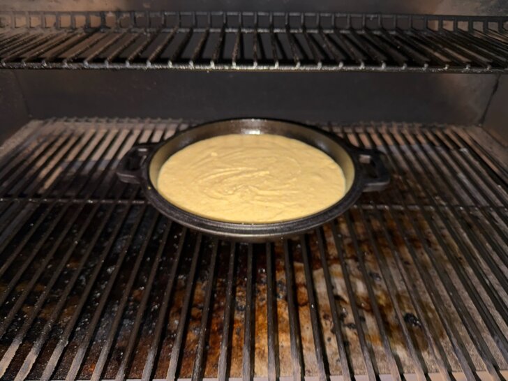 cornbread batter in cast iron skillet on grill