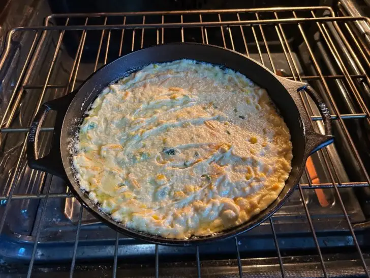 cornbread batter in skillet on oven rack
