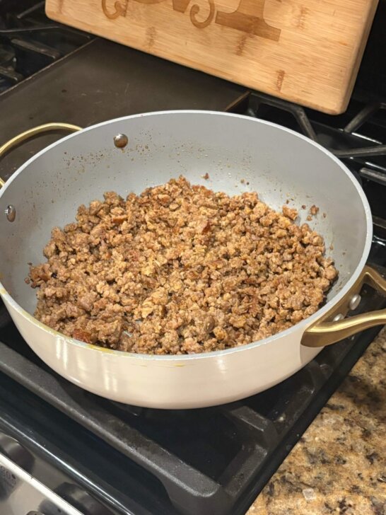 sausage frying in skillet