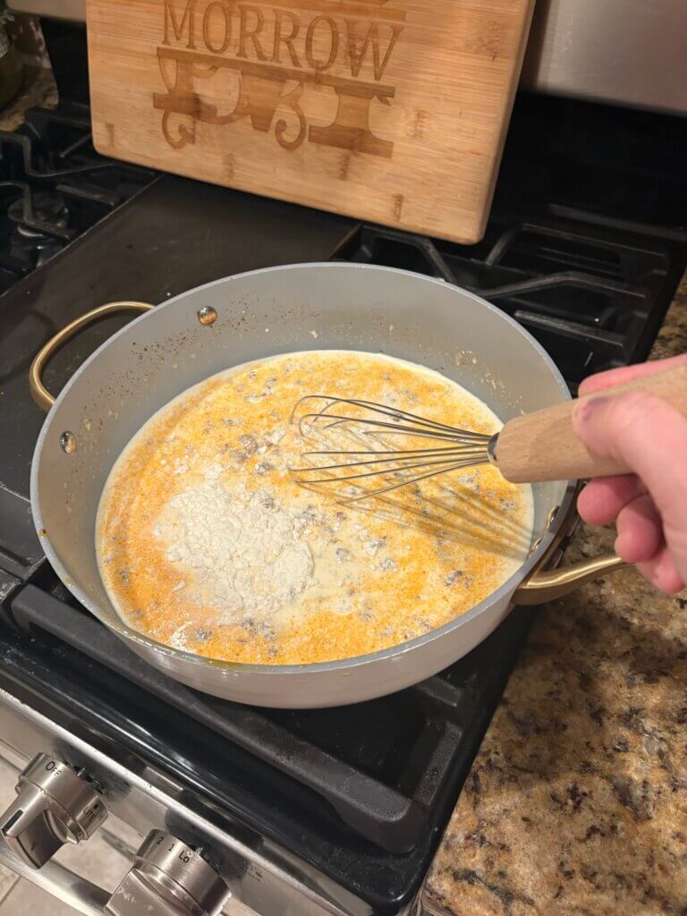 cheese sauce in pan with whisk