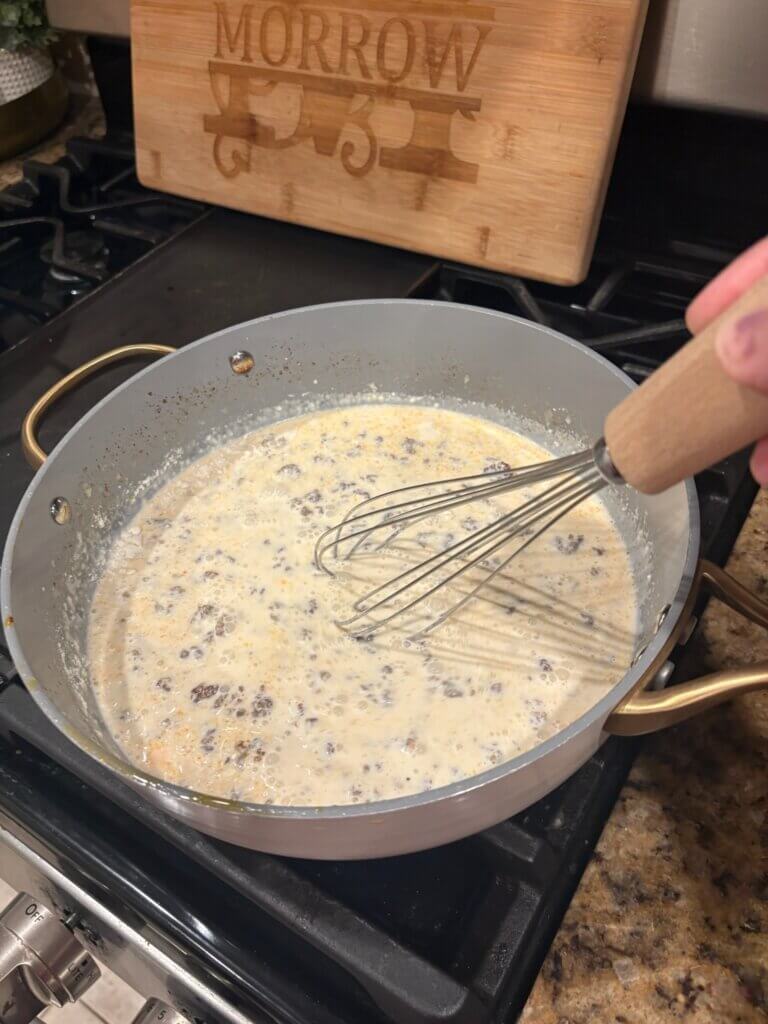 cheese sauce in pan with whisk
