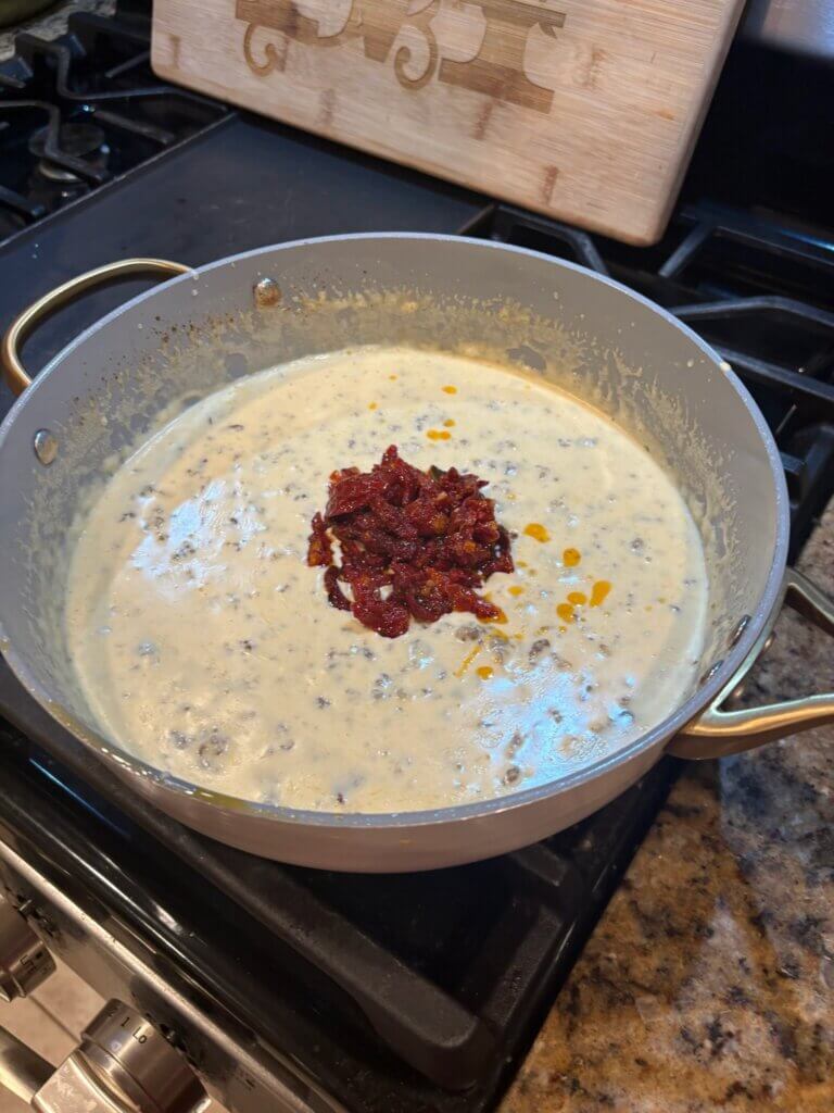 cheese sauce in pan ith sun dried tomatoes