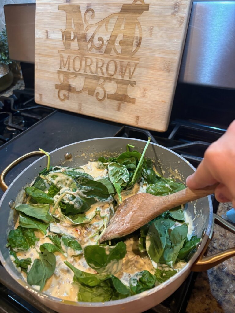 cheese sauce in pan with spinach