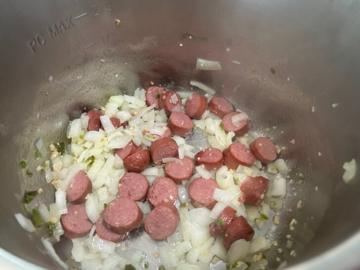 sauteed onion, sausage, and pepper, adding garlic