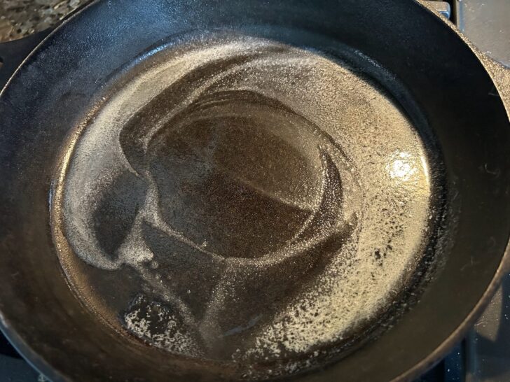 cast iron skillet with melted butter