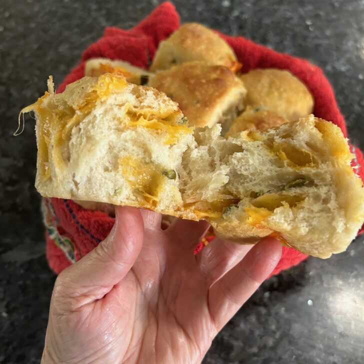 Same Day Jalapeno Cheddar Sourdough Rolls Interior view of cheddar pockets and bits of jalapeno