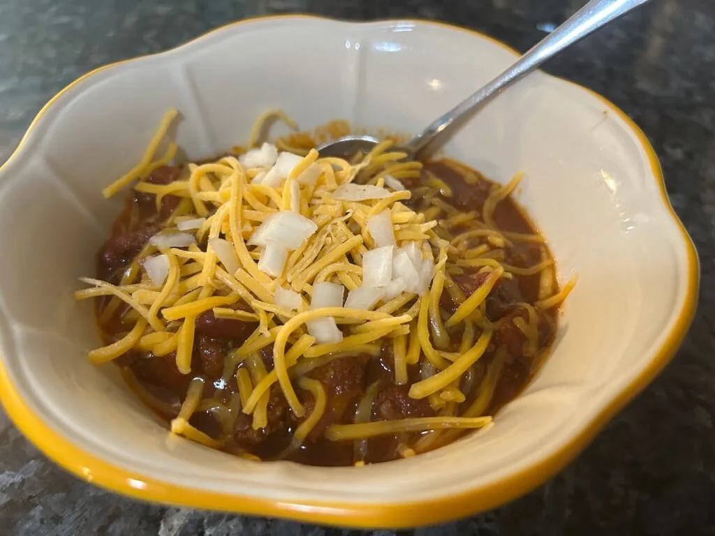 Smoky Texas Chili with cheese and onions