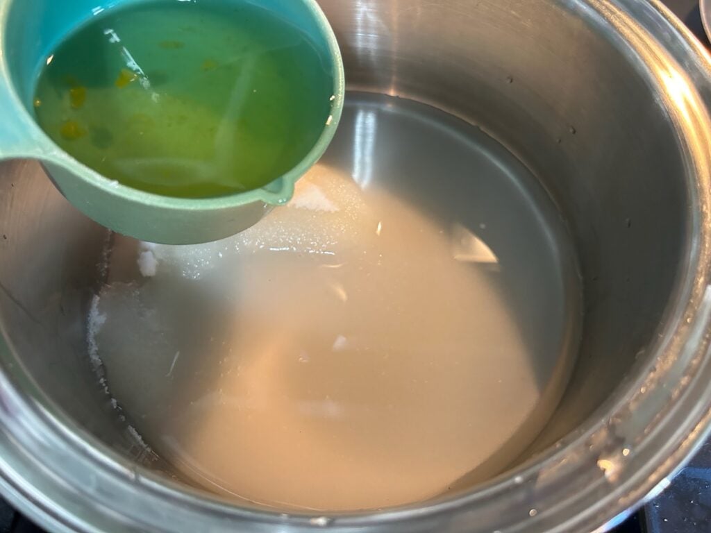 water and sugar syrup in pan on stove