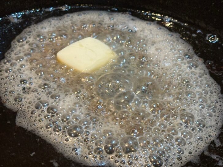 oil and butter simmering in cast iron skillet
