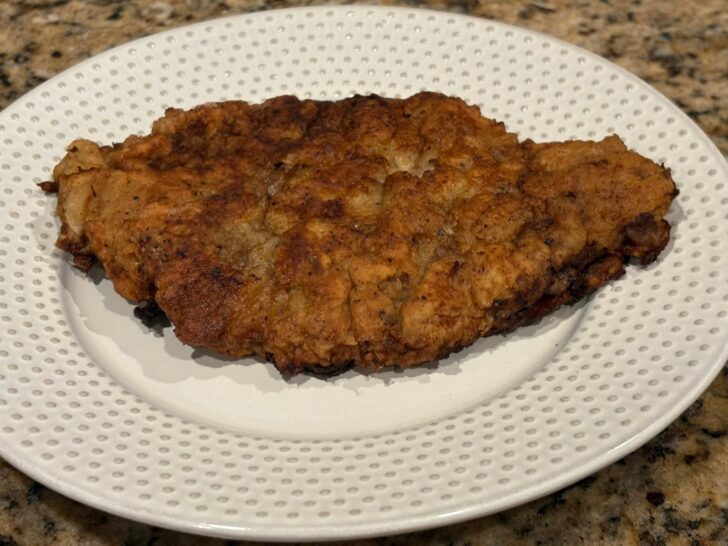 chicken fried steak on plate, crisp edges