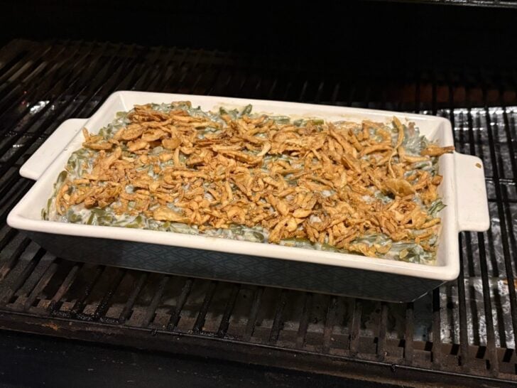 green bean casserole with french fried onions on top in smoker