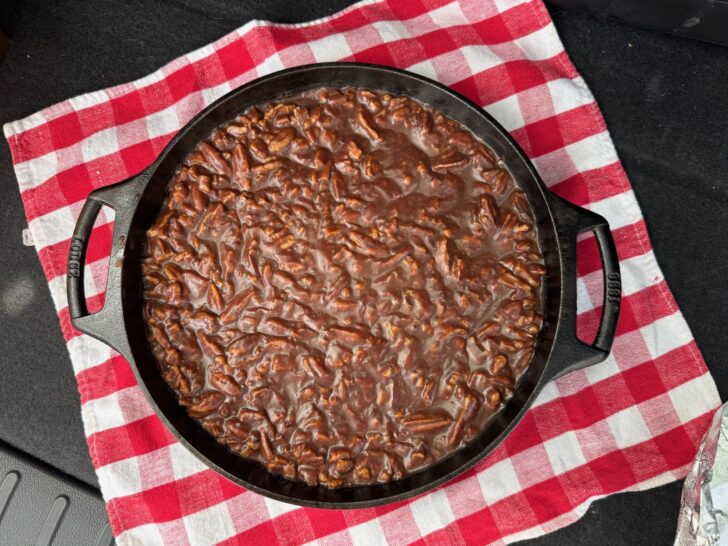 texas sheet cake brownies with icing in cast iron skillet