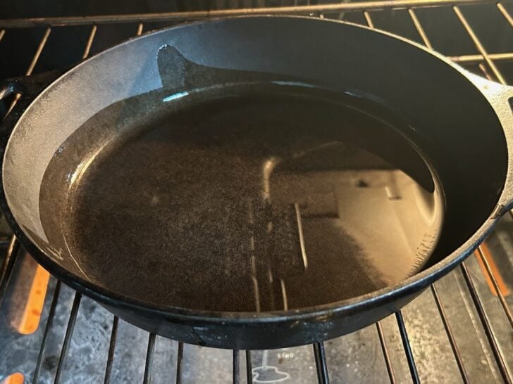 cast iron skillet in oven (with oil in it)