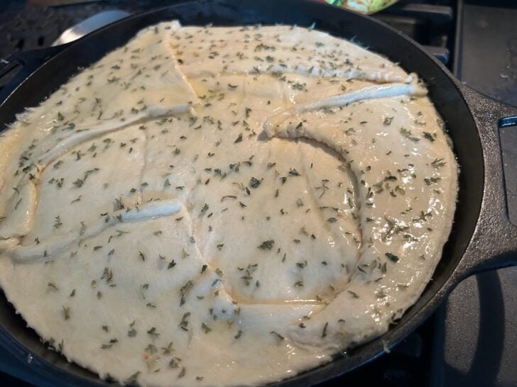 crescent roll crust with butter and parsley on top