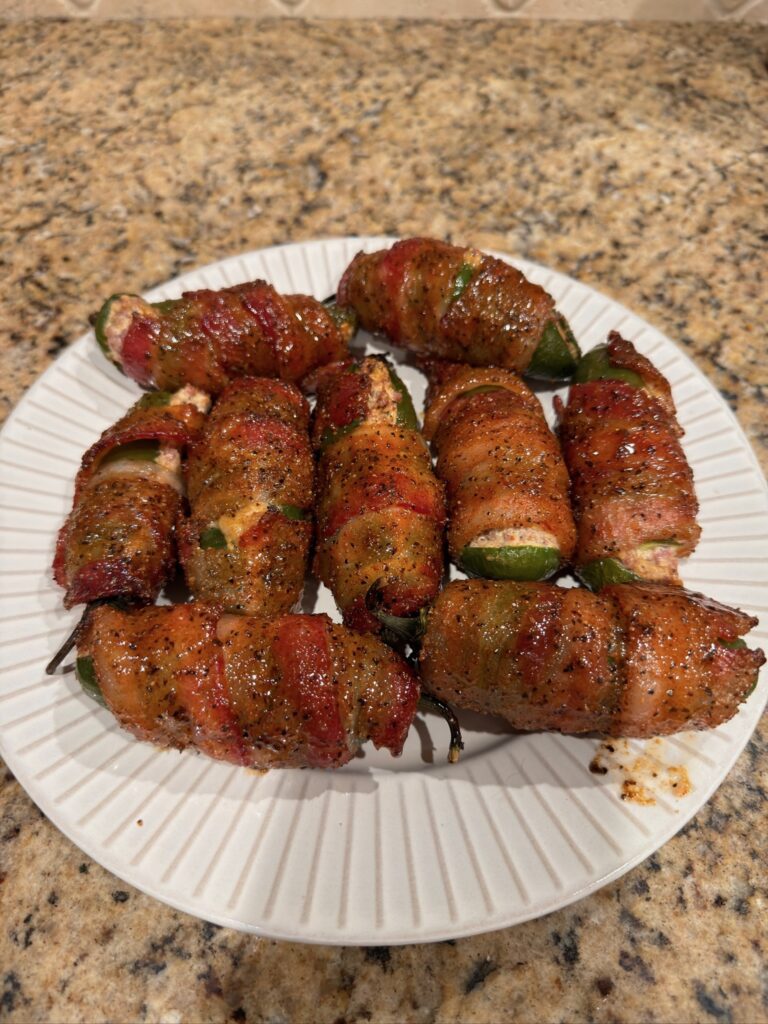 bacon wrapped stuffed jalapenos cooked, on plate