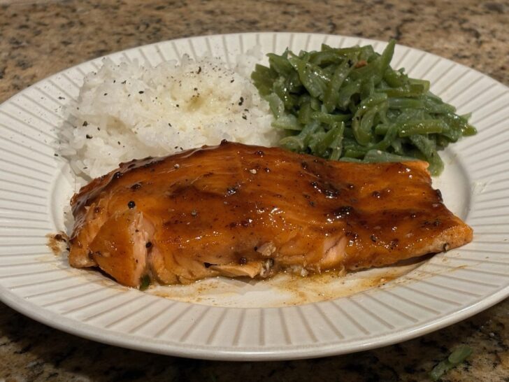 cooked salmon, rice, and green beans on plate