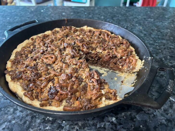 texas trash pie in cast iron skillet, one slice removed