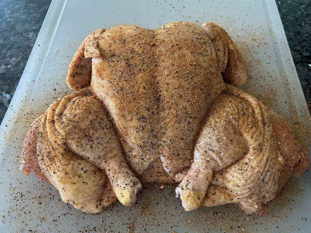spatchcocked chicken, seasoned and ready to be grilled