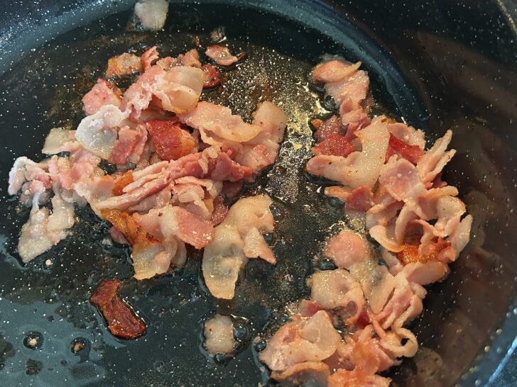 bacon sauteeing in skillet