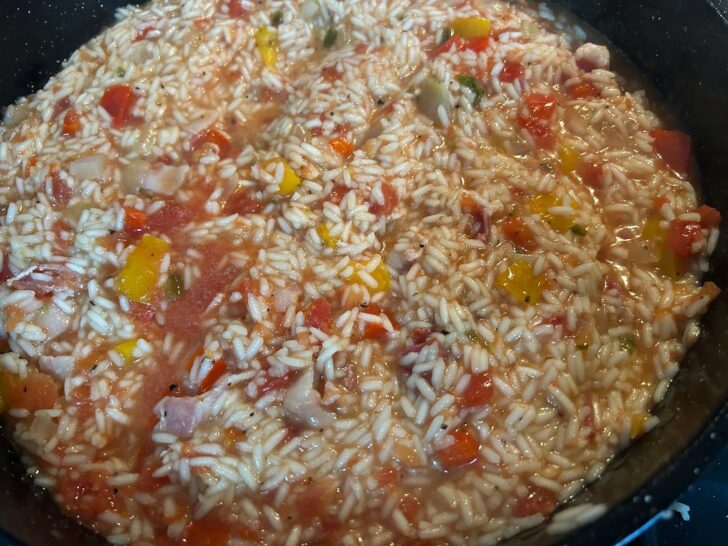rice cooking in skillet with vegetables