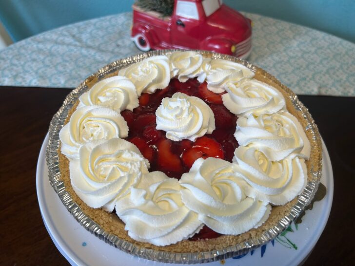 strawberry pie, decorated with whipped cream rosettes