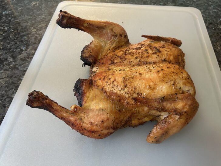 cooked chicken on cutting board, resting