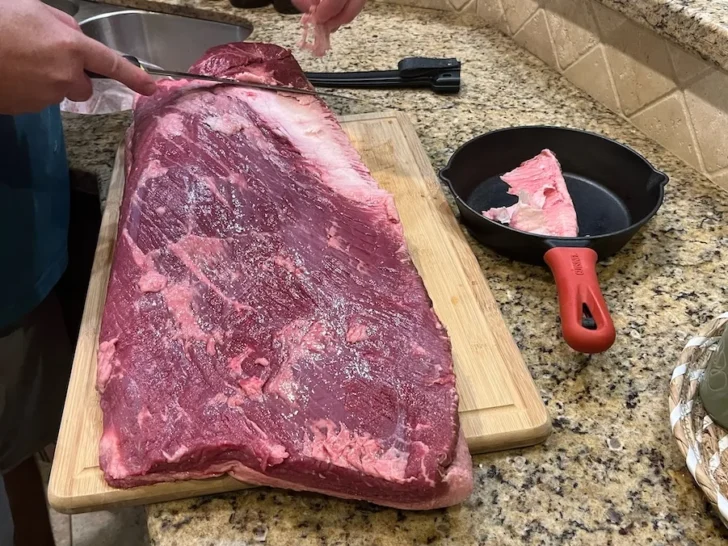 beef brisket being trimmed