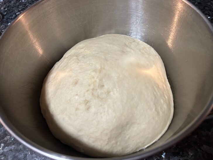 risen bread dough in bowl