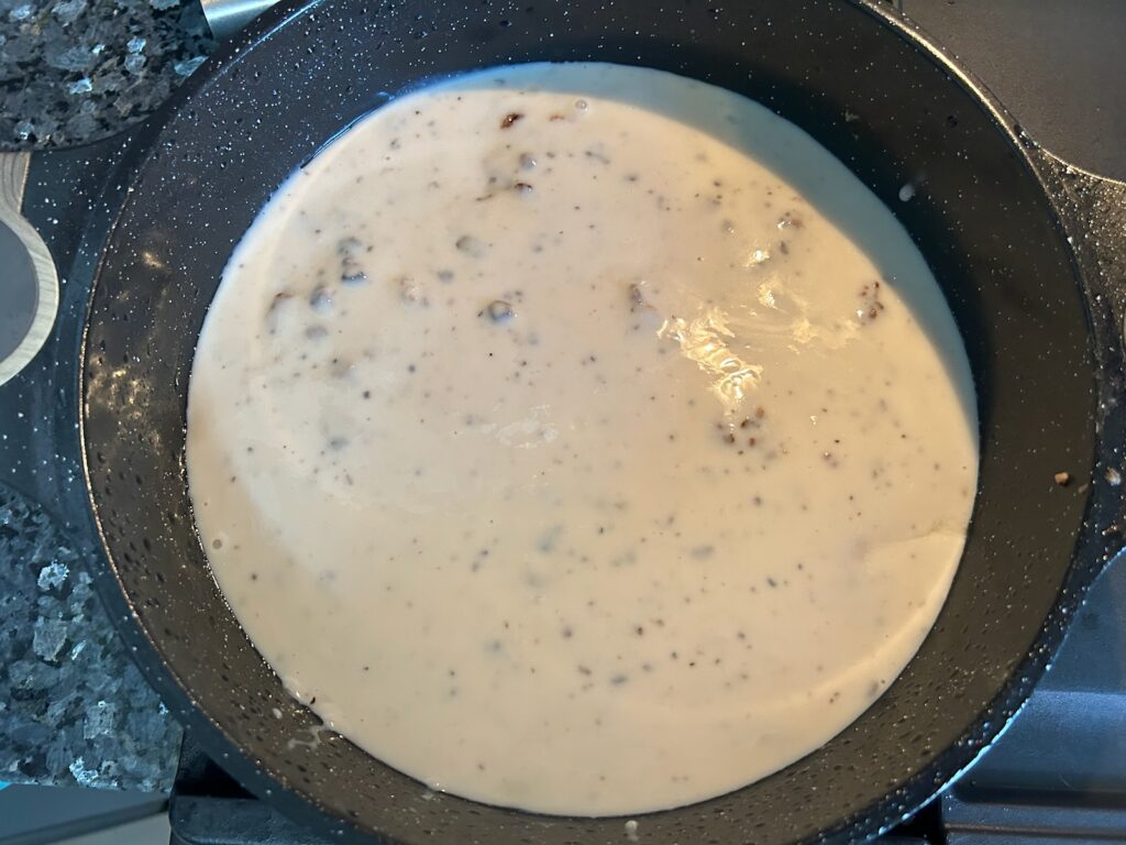 beef steaks in pan smothered in mushroom gravy