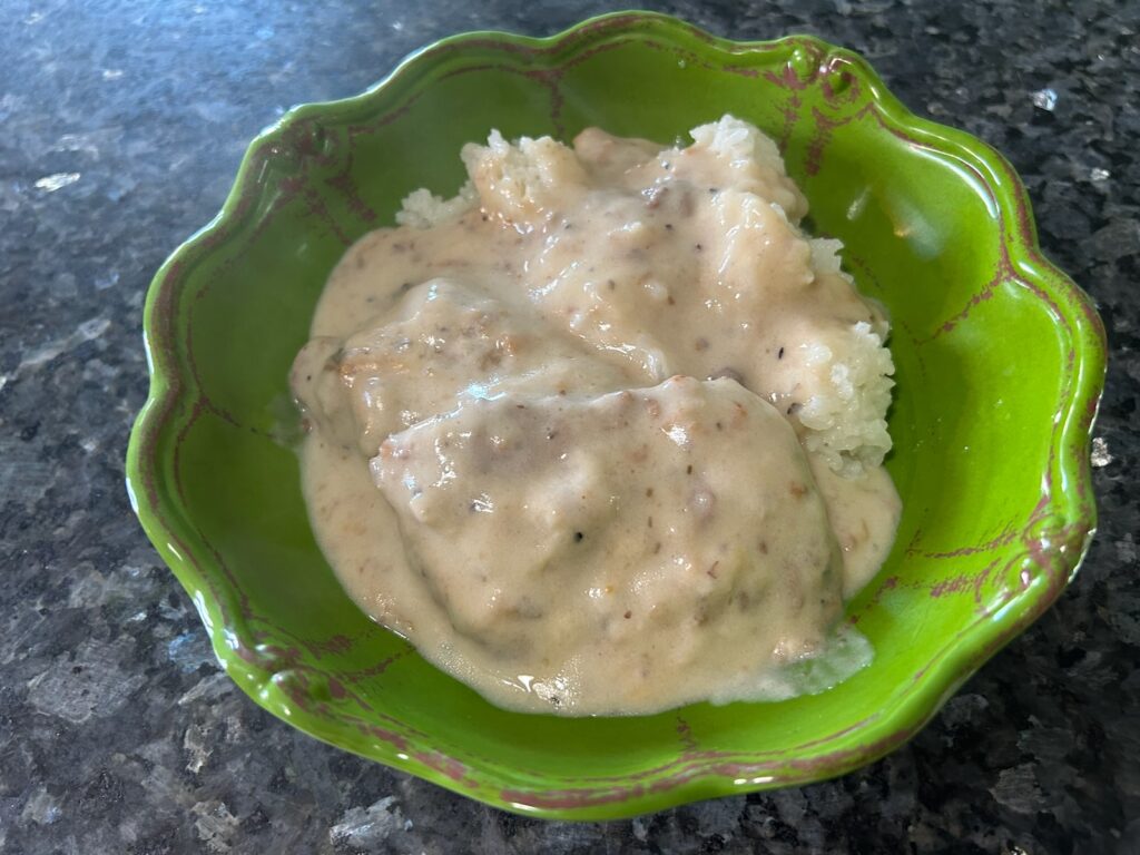 smothered round steak with mushroom gravy and rice in bowl