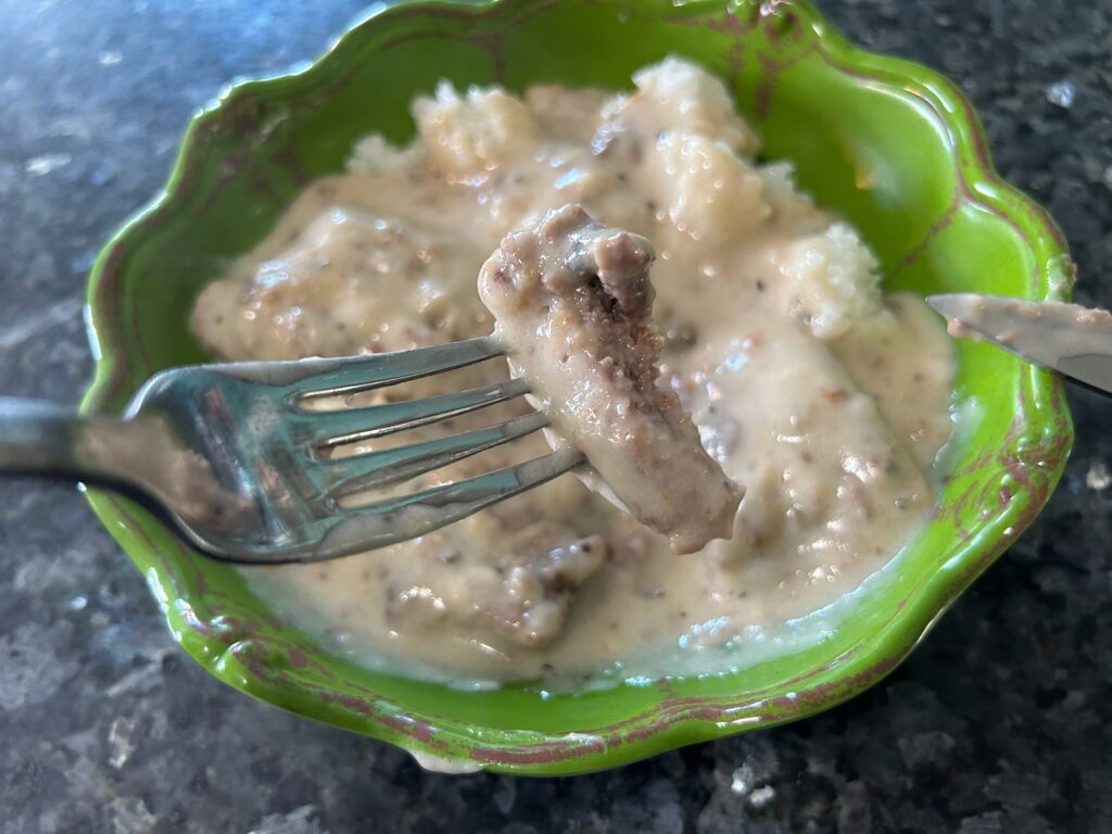 smothered round steak with mushroom gravy and rice in bowl