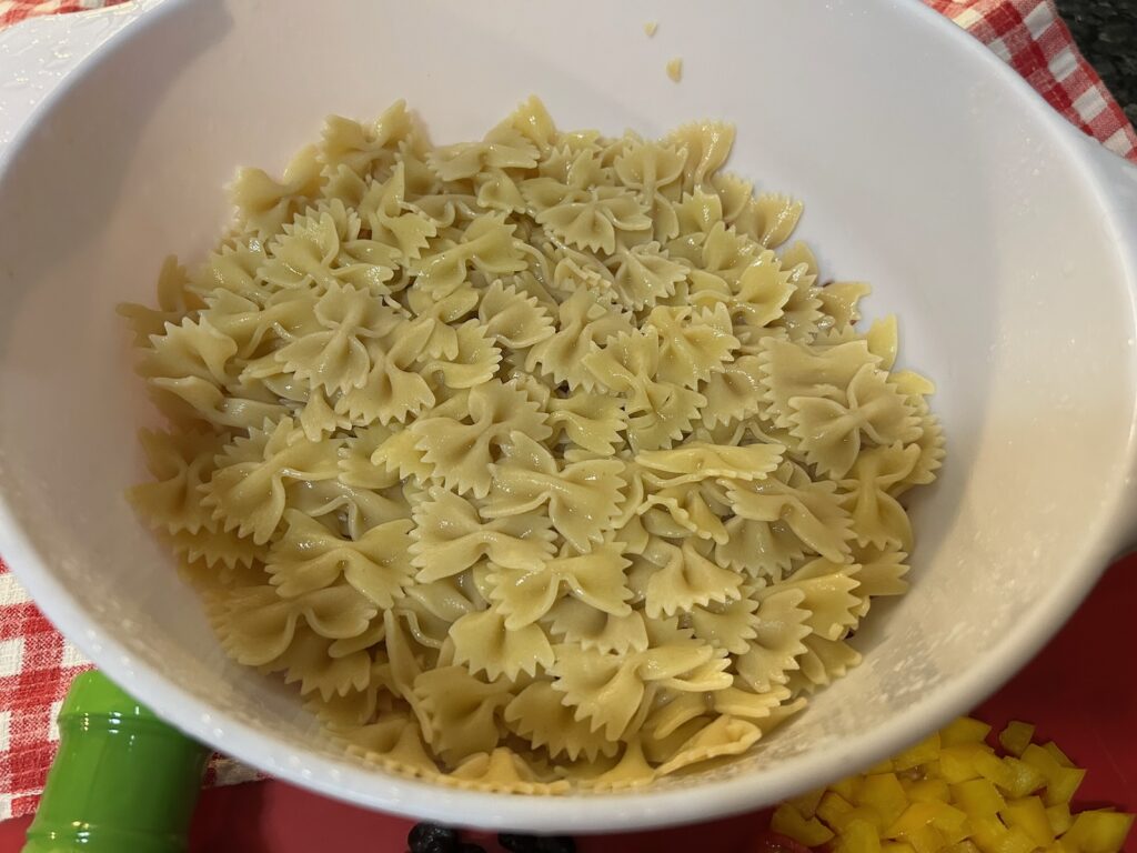 cooked bowtie pasta in strainer