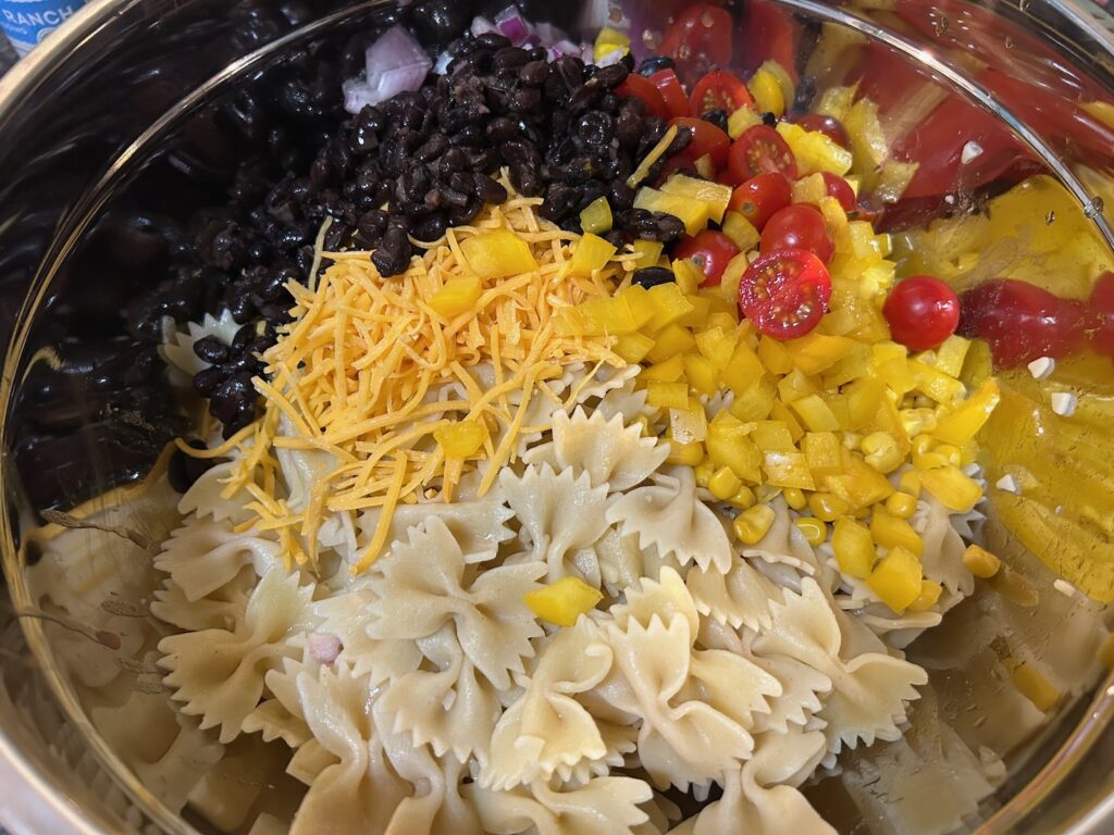cooked pasta in bowl with other pasta salad ingredients