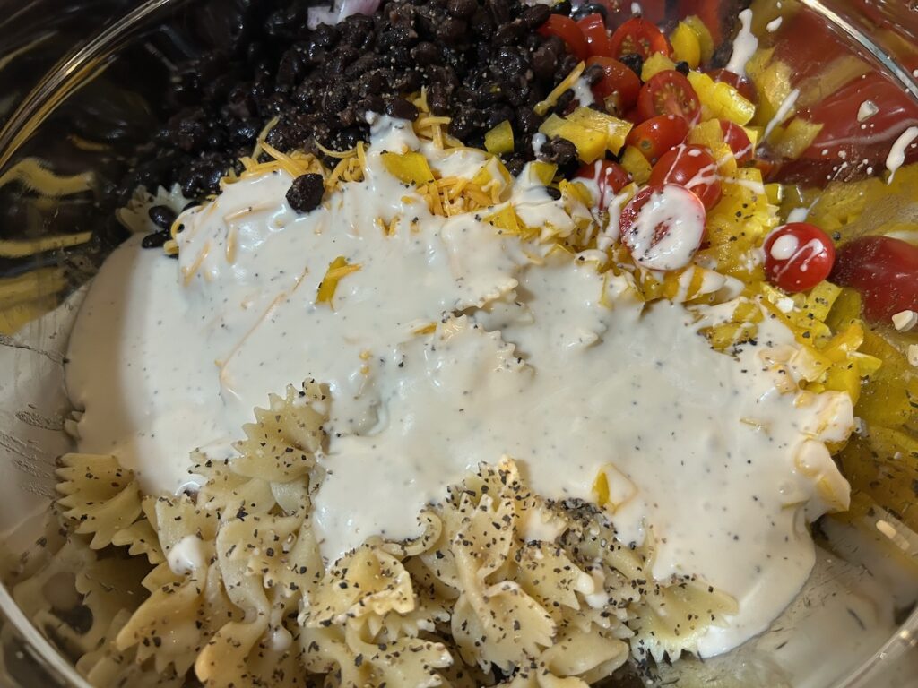 cooked pasta in bowl with other pasta salad ingredients
