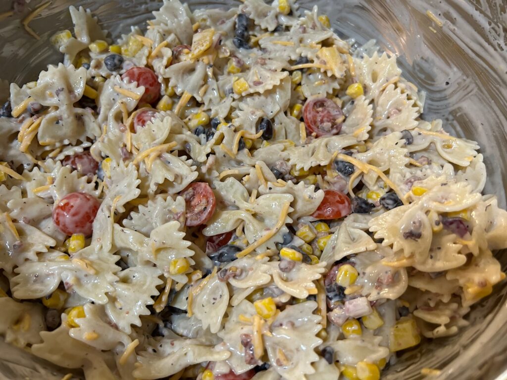 pasta salad freshly mixed in large bowl