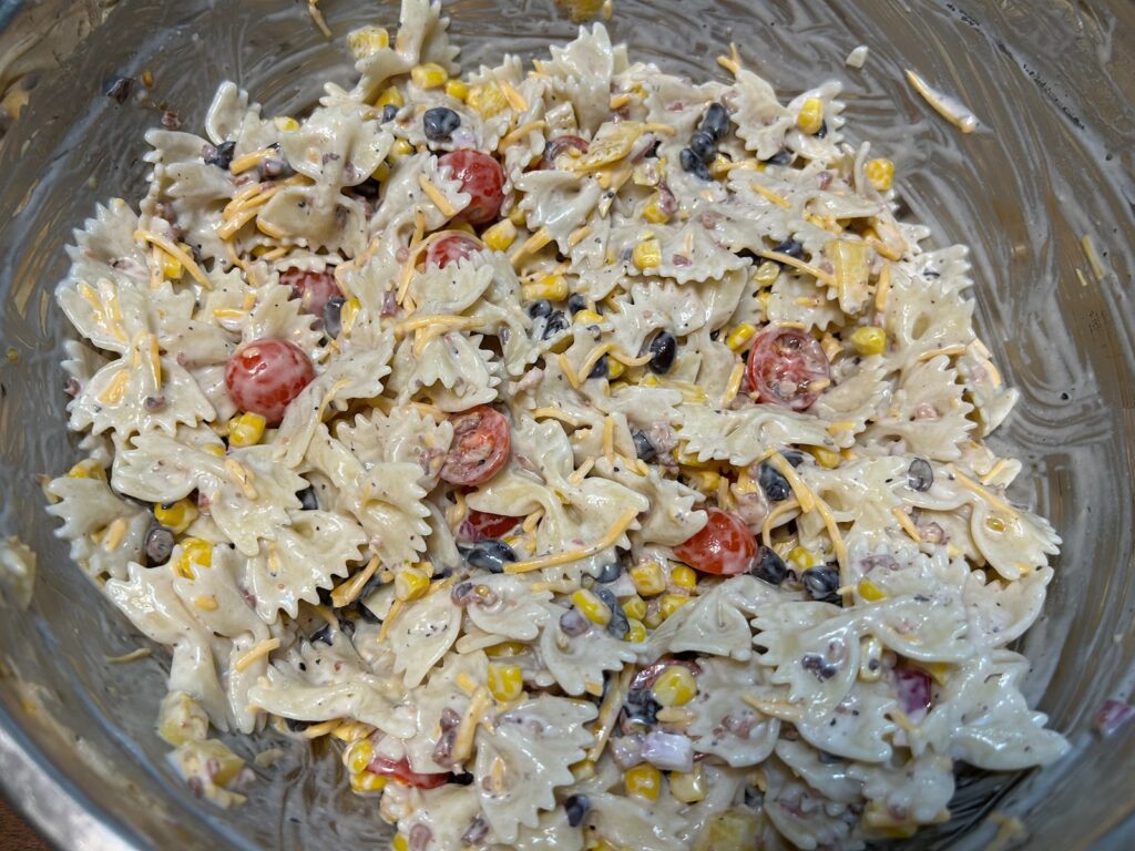 pasta salad freshly mixed in large bowl