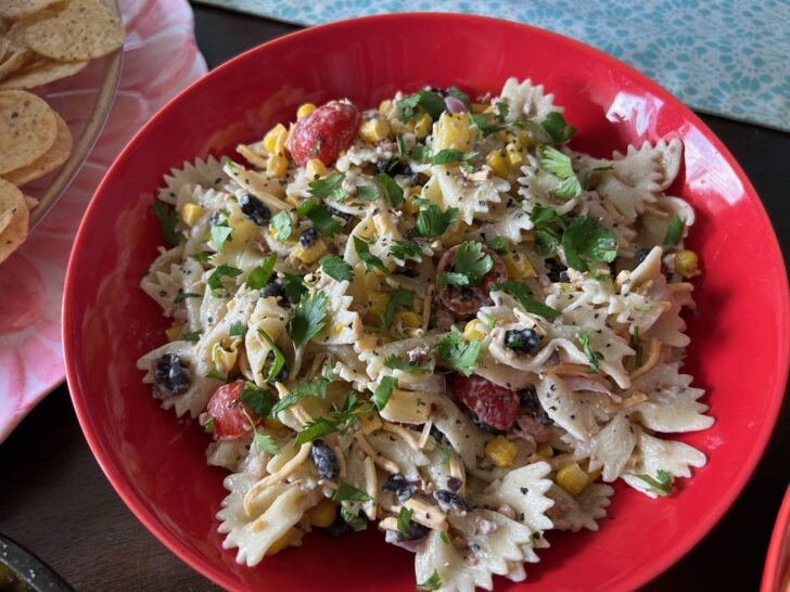 pasta salad in pretty bowl, garnished with cilantro
