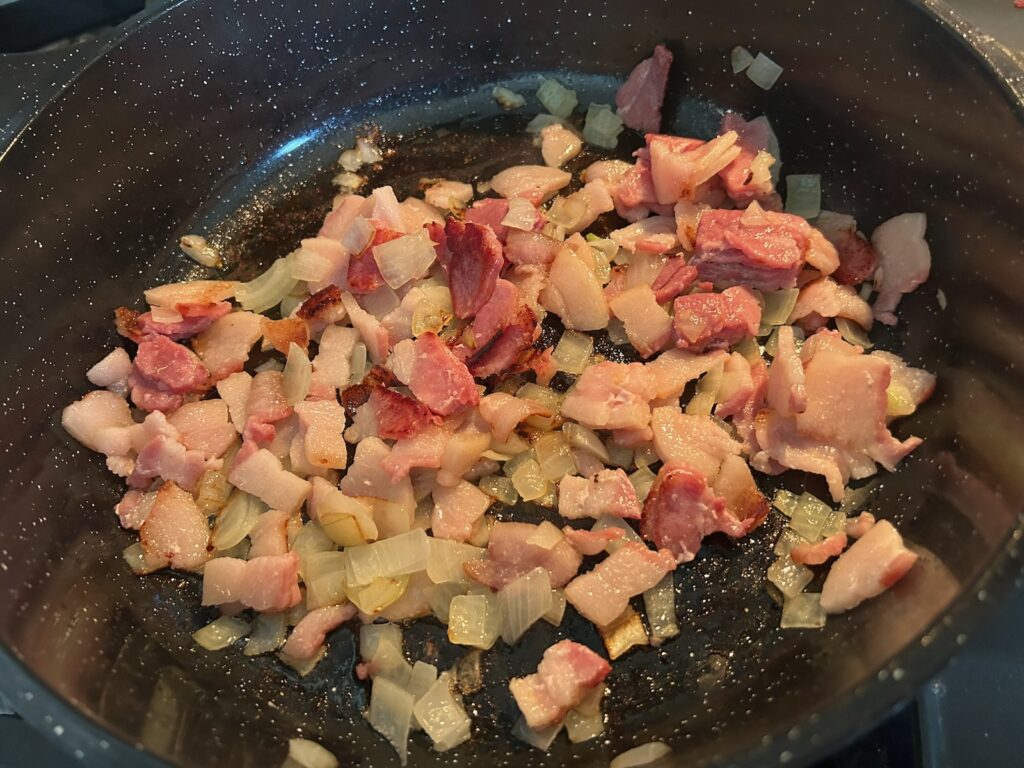 onions and bacon simmering on the stove