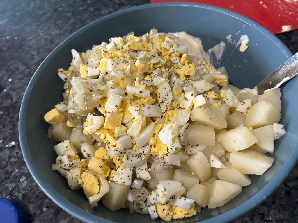 cubed potatoes with mayo, mustard, diced egg, and spices