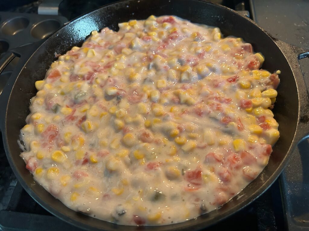 mushroom soup with rotel and corn in cast iron skillet