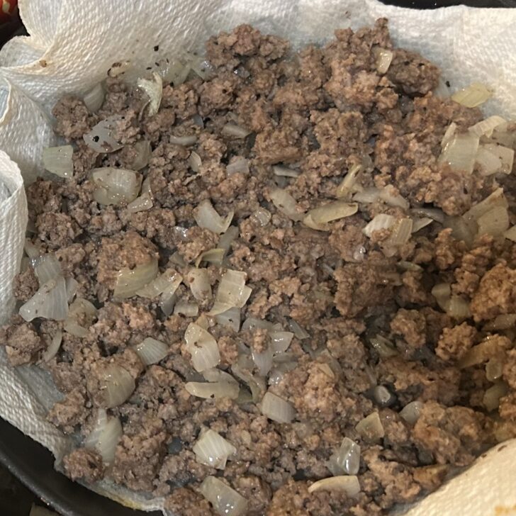 ground beef and onions, cooked and draining on paper towels