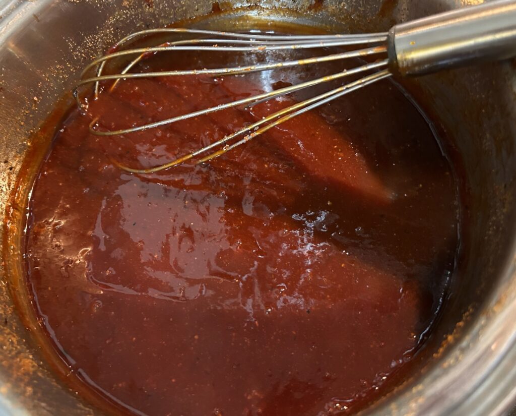 Foolproof Texas BBQ Sauce simmering on stove