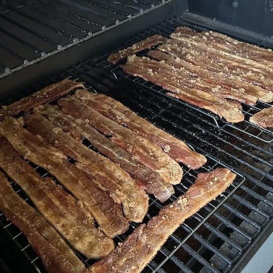 bacon cooking on the grill
